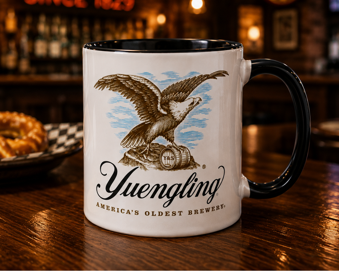 Classic Yuengling coffee mug featuring America’s Oldest Brewery eagle logo on white ceramic with black handle and interior.
