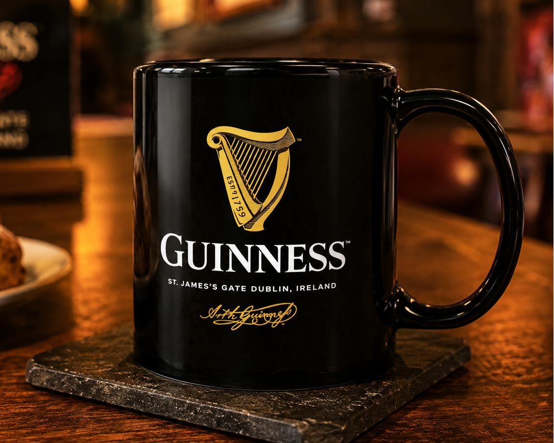 Guinness harp logo coffee mug with black ceramic finish, featuring the iconic Irish stout branding and gold harp design on premium drinkware.