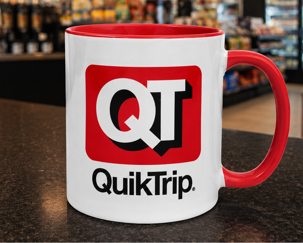 QuikTrip QT logo coffee mug with classic convenience store branding on a white ceramic mug featuring a red handle and interior, perfect for travel stop enthusiasts and collectors.